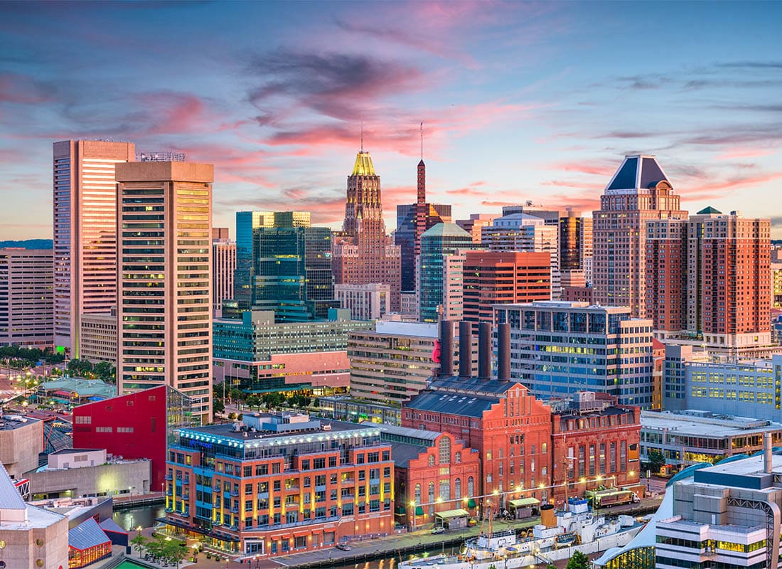 Contact - Aerial Scenic View of the Downtown Cityline in Baltimore, Maryland During Sunrise